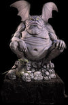 Grumpy Gargoyle fat animatronic prop sits on a pile of skulls.