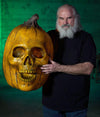 Distortions owner Ed Edmunds holds Giant Blazing Pumpkin wall hanging prop