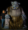 Colossus giant animatronic sleeping next to Distortions owner Marsha Taub-Edmunds 