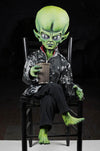 Moveable Green Martian alien prop dressed with coffee cup.