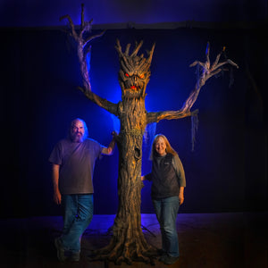 Haunted Tree Halloween decoration prop stands over 9 feet tall with Ed and Marsha of Distortions Unlimited