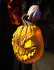 Headless Horseman prop holding glowing pumpkin in hand