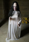 La Llorona Halloween Prop dressed in white with long black hair crying tears of blood.