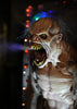 Mutant animatronic prop with scary face and sharp teeth spraying water from mouth