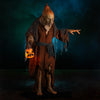 Pumpkin Witch prop standing in creepy green and spooky blue fog in a haunted scene