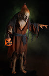Pumpkin Witch haunted prop stands in the dark with creepy green fog and glowing evil jack o lantern