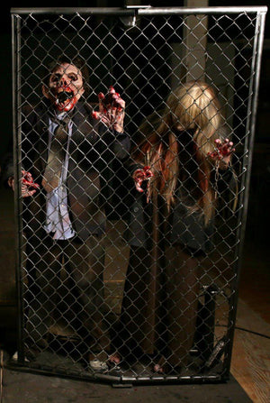 Zombie Breakout scare with animatronic zombie and actor in zombie costume behind fence